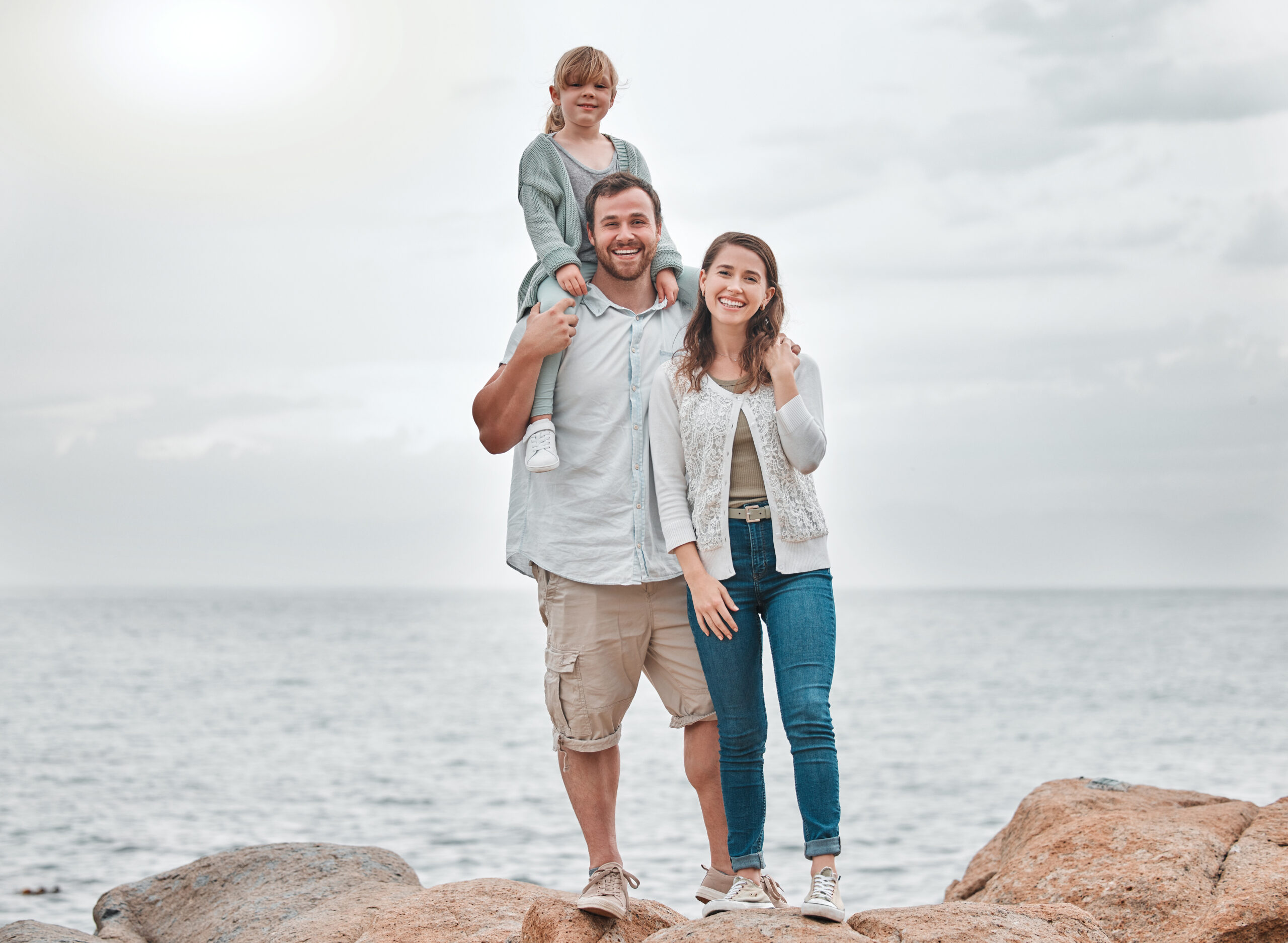 Family near South Florida beach condo buildings exploring condo financing