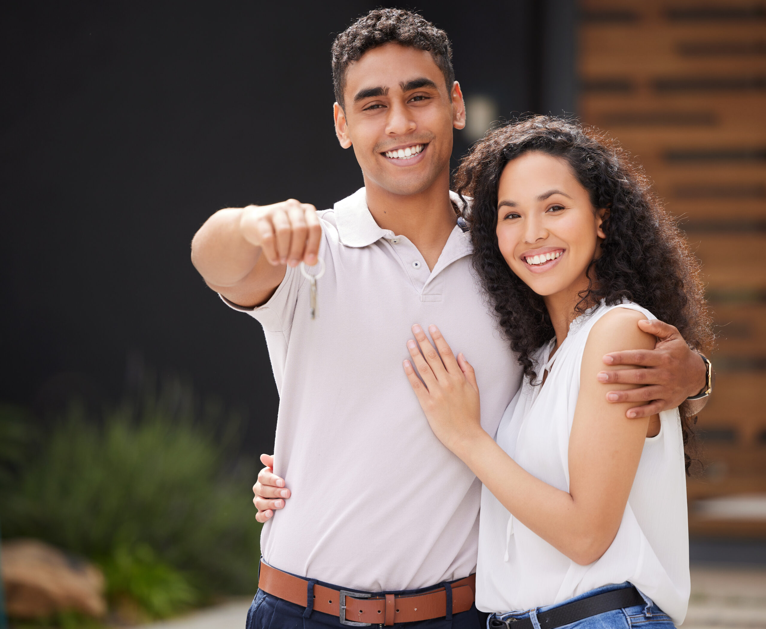 Couple holding keys to a new home bought with down payment assistance in Florida